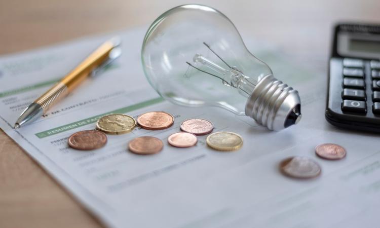 Light bulb, coins and paper