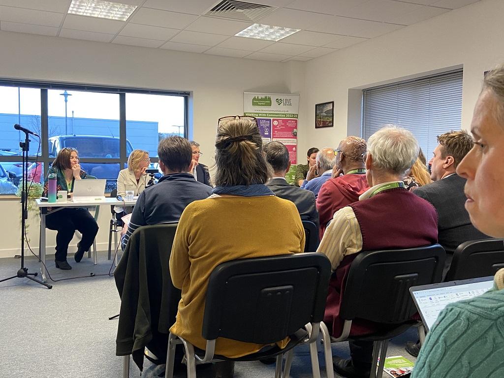 DCT AGM 2023 - back of audience heads, seated, facing a panel