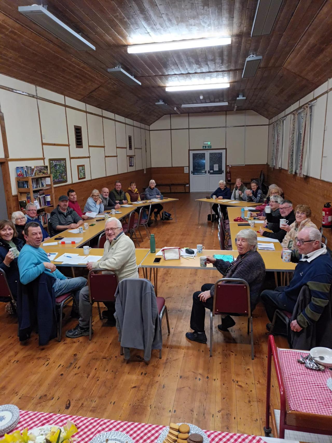 Torridge VH cluster meeting, group of people smiling in a village hall