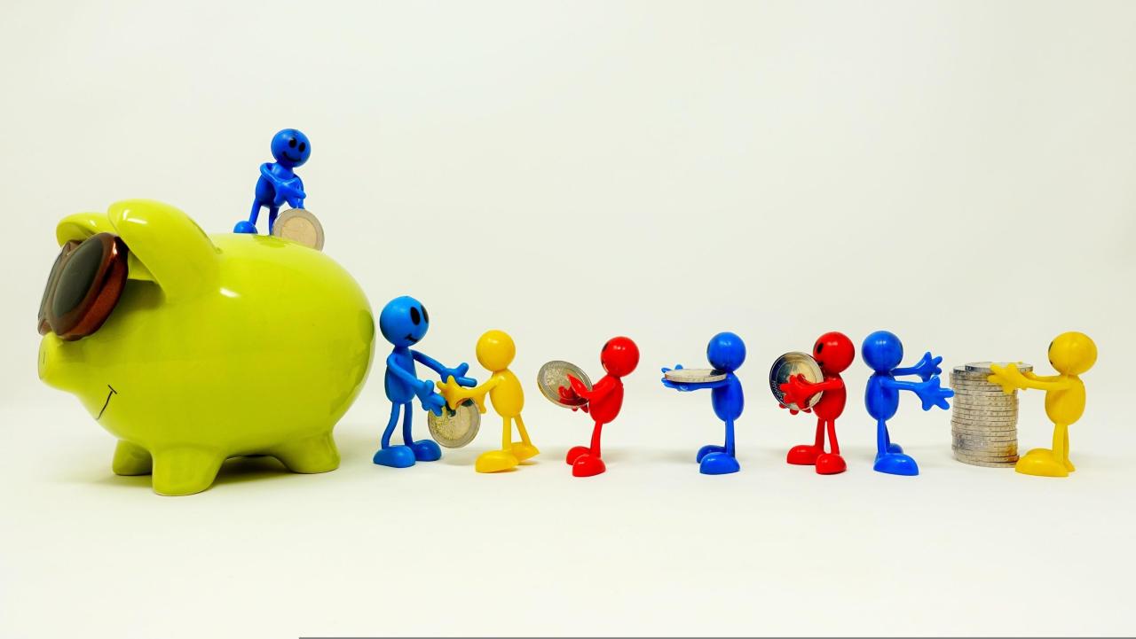 toy people putting money in a piggy bank