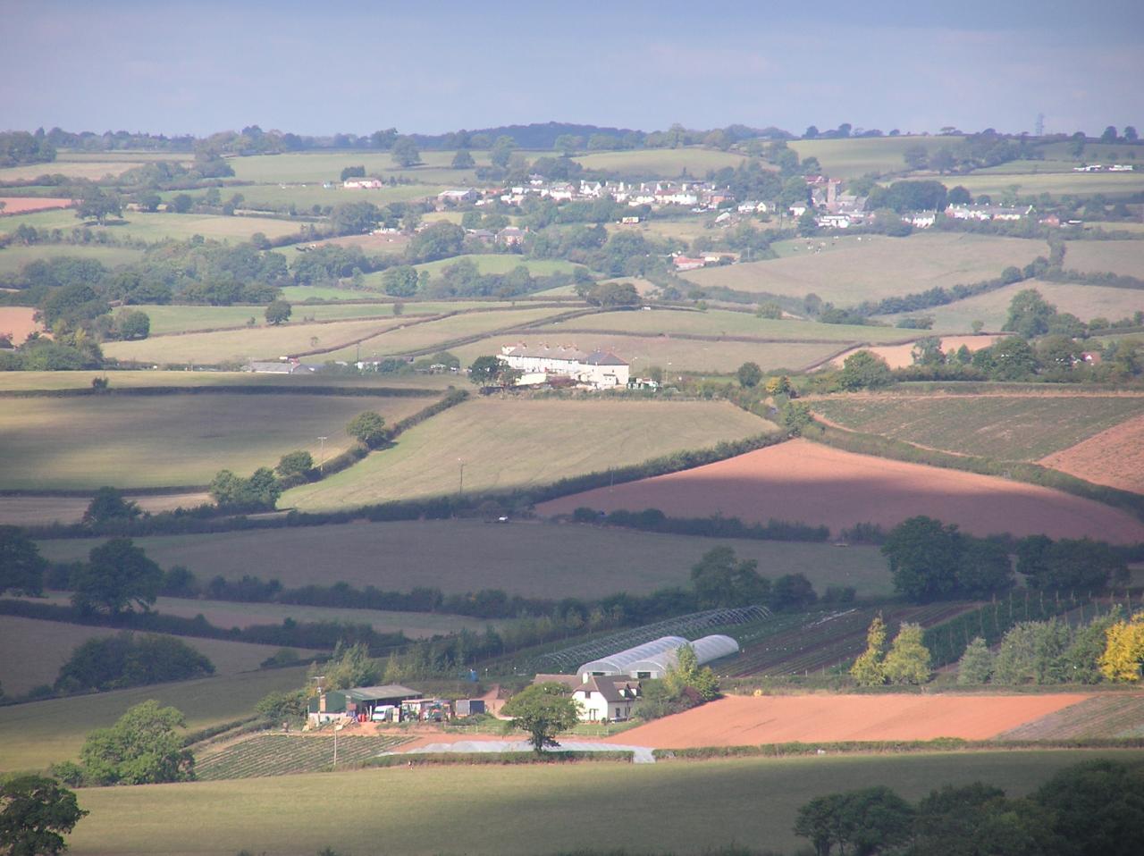 landscape showing a farm, fields and houses