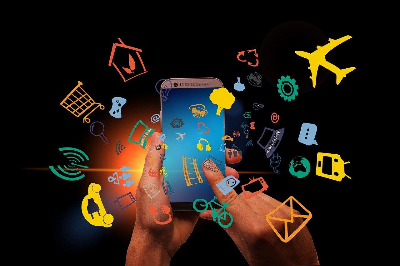 hand hovering over a smart phone with illustrations surrounding it, depicting the different apps and functions