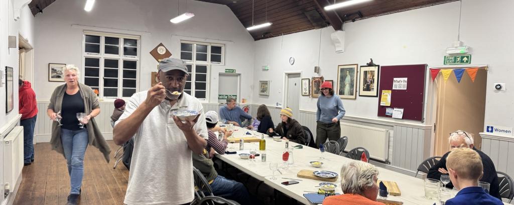 Inside a village hall with people seated at a table