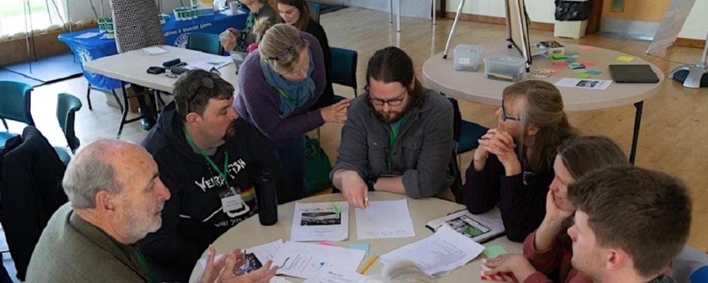 People sat around a table at a conference