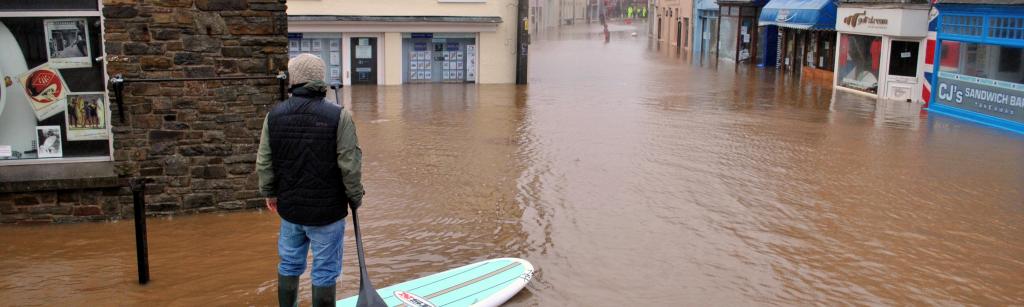 man on surfboard during a flood