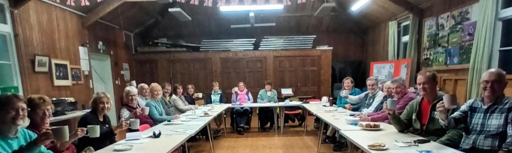 Village hall interior with people sitting round a table