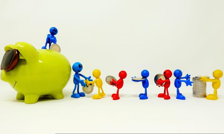 toy people putting money in a piggy bank