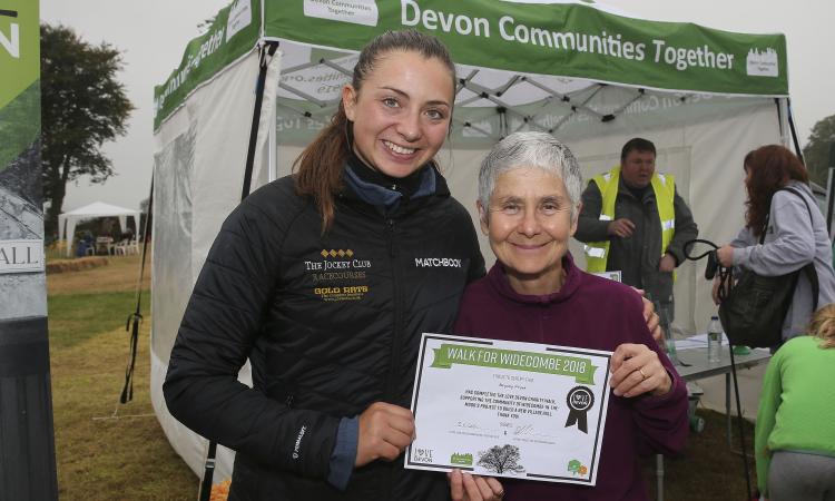 teresa Butchers receives her certificate from Bryony Frost