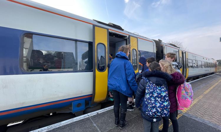Young people getting on train
