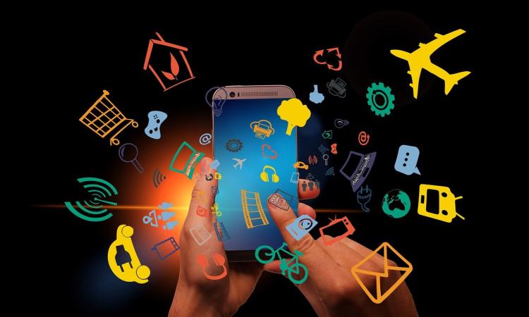 hand hovering over a smart phone with illustrations surrounding it, depicting the different apps and functions
