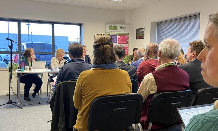 DCT AGM 2023 - back of audience heads, seated, facing a panel