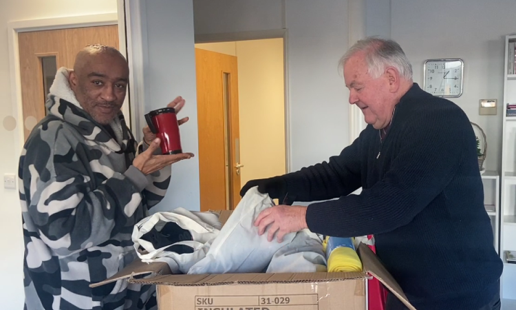 martin and anderson unpacking a box full of winter essentials